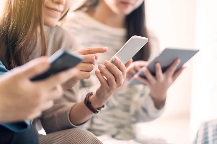 A visual representation of TikTok influencers and creators discussing and participating in trending challenges, surrounded by digital icons and symbols representing various popular trends, highlighting the platform's role in shaping digital culture.