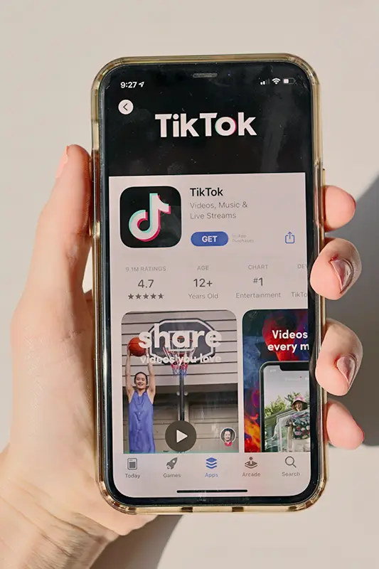 A visual representation of TikTok creators sharing eco-friendly tips and hacks, such as composting or using reusable products, with supportive comments and engagement from viewers, highlighting the platform's potential to inspire sustainable living practices.